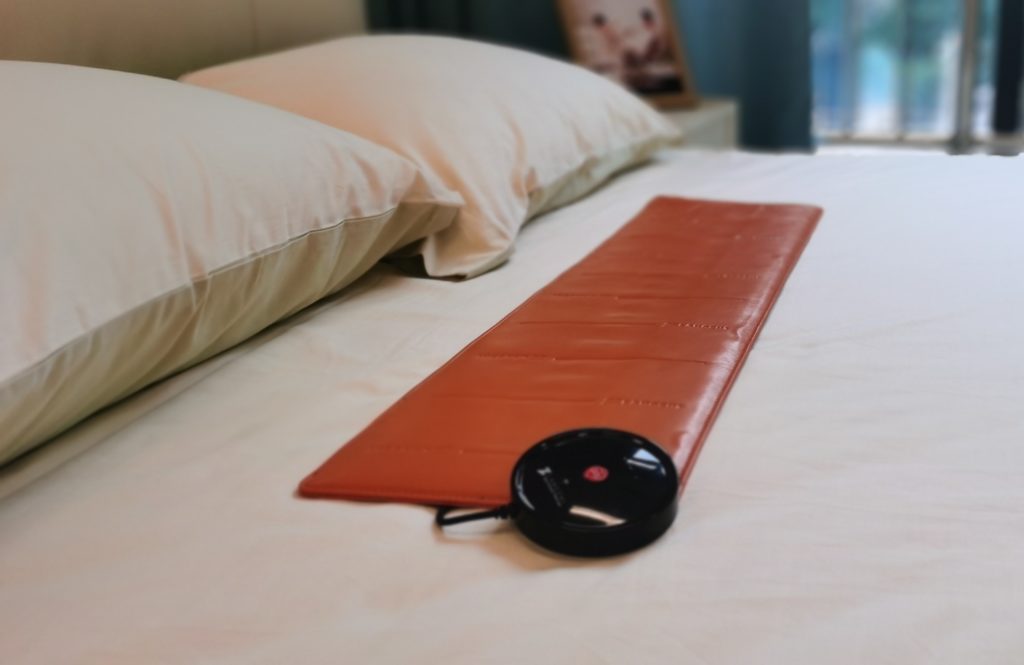 Orange Digital Care Pad on Bed