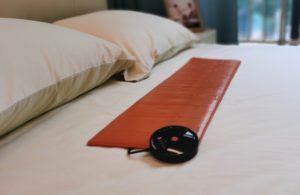Orange Digital Care Pad on Bed