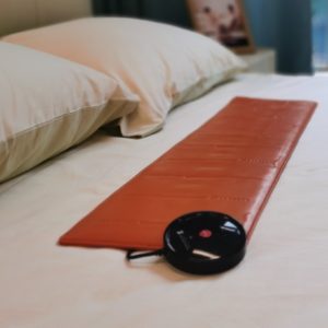 Orange Digital Care Pad on Bed